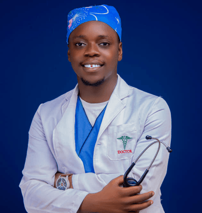 Dr. Femi Rotifa in his white coat and blue scrubs